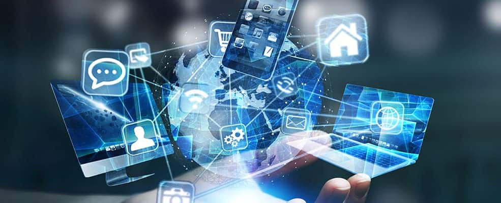 A hand holding a phone displaying multiple social media icons, emphasizing the importance of cyber security and IT support.