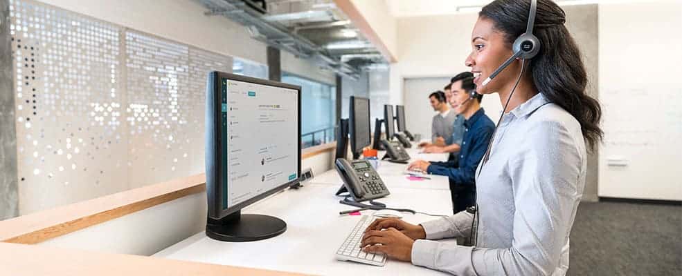 IT Technician using headset and computer