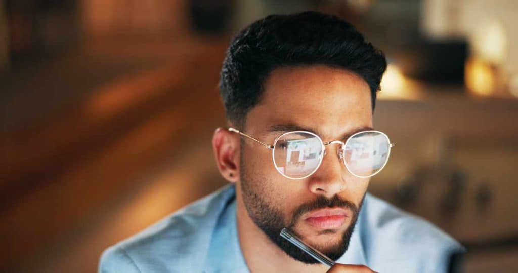 Night, reflection and glasses of businessman at computer for digital, software and web design programming. Strategy, designer and coding with employee in office and overtime for managed it services for cybersecurity network.